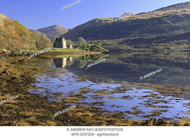 Dunderave Castle in Argyll and Bute, Scotland, reflected in Loch Fyne on an afternoon in late October