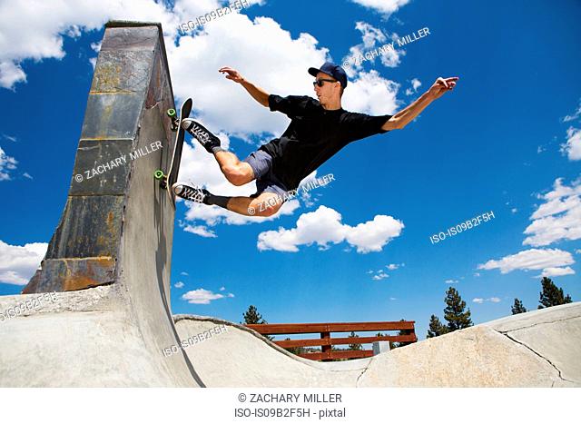 Young man skateboarding in skate park ramp, Mammoth Lakes, California, USA