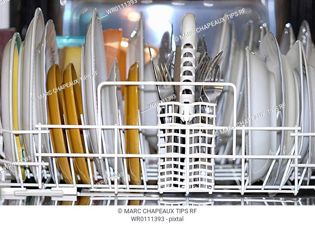 Cleaned dishes and cutleries in dishwasher