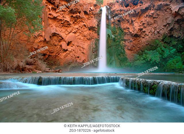 Low angle view in the Grand Canyon as Mooney Falls drop into turquoise pool, USA, Arizonal