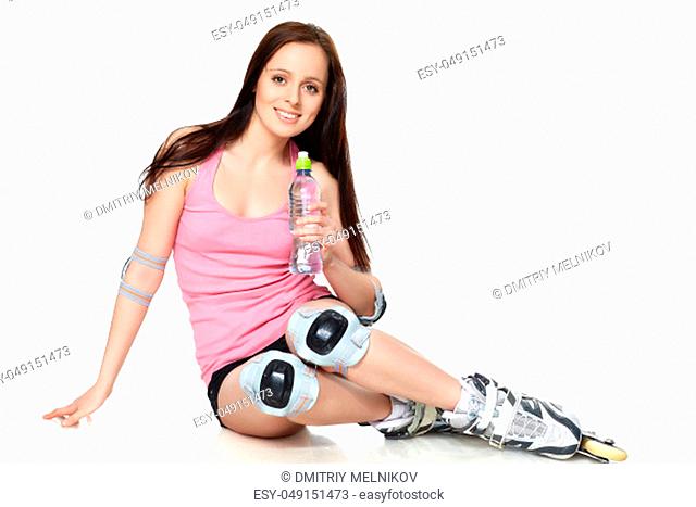The beautiful young woman in rollerskates on a white background
