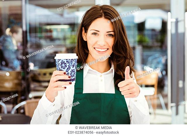 Smiling waitress serving a coffee