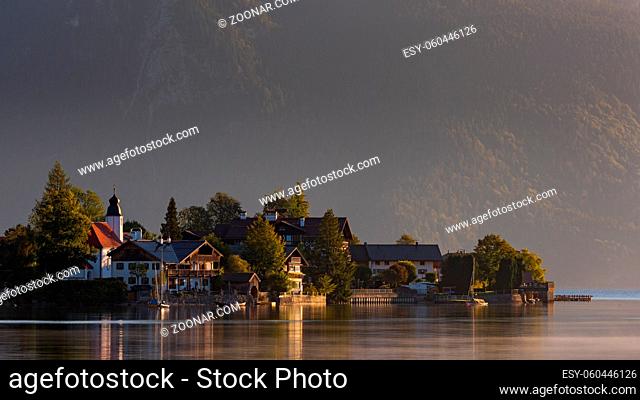 The village Walchensee on the alpine mountain lake Walchensee with mountains in background in early morning dawn