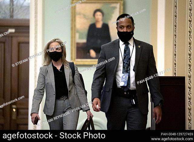 Representative Madeleine Dean, a Democrat from Pennsylvania, left, wears a protective mask while walking through the U.S. Capitol in Washington, D.C