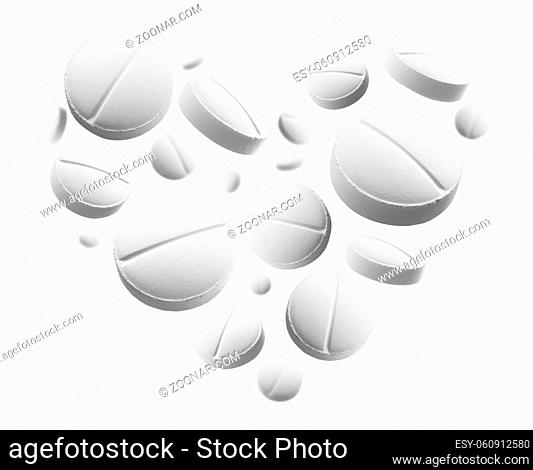 White round tablets in the shape of a heart on a white background