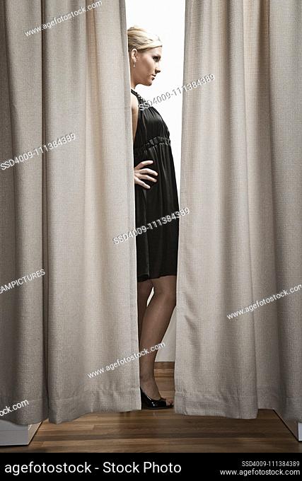 Caucasian woman trying clothes in dressing room