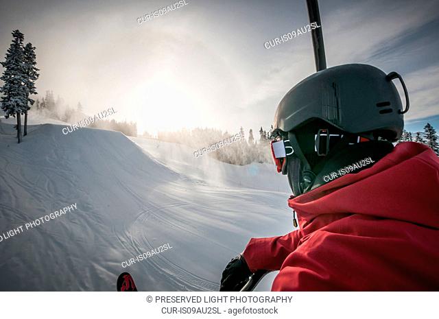 Over shoulder view of skier on snowy landscape, Whistler Blackcomb, British Columbia, Canada