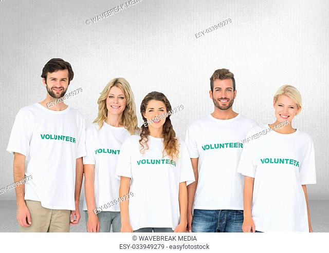 Group of volunteers standing in front of blank grey background