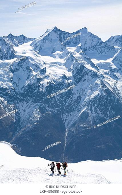 Three skier ascending to mount Bishorn, Mischabel mountain range with Dom and Taschhorn in background, Turtmann valley, Canton of Valais, Switzerland