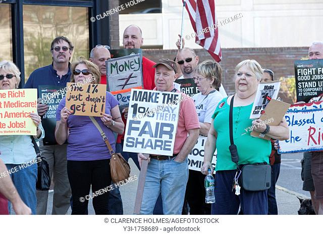 Members of the Communications Workers of America CWA Local 1103 and MoveOn participate in the Tax the 1 protest at the post office in White Plains, New York