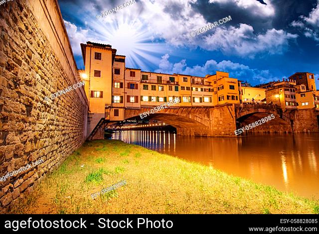 Ponte Vecchio over Arno River, Florence, Italy. Beautiful upward wide angle view at sunset