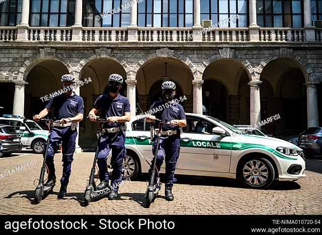 Local police officers on electric scooters patrol in piazza Duomo in Milan. The new service of the Local Police on a scooter is dedicated to the control of...