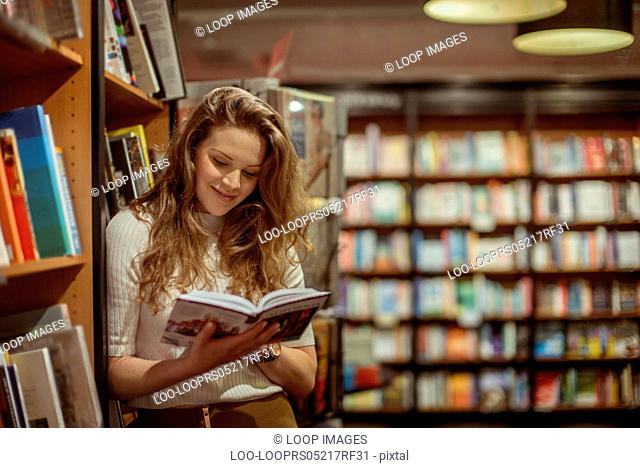 A young woman browses in a book store