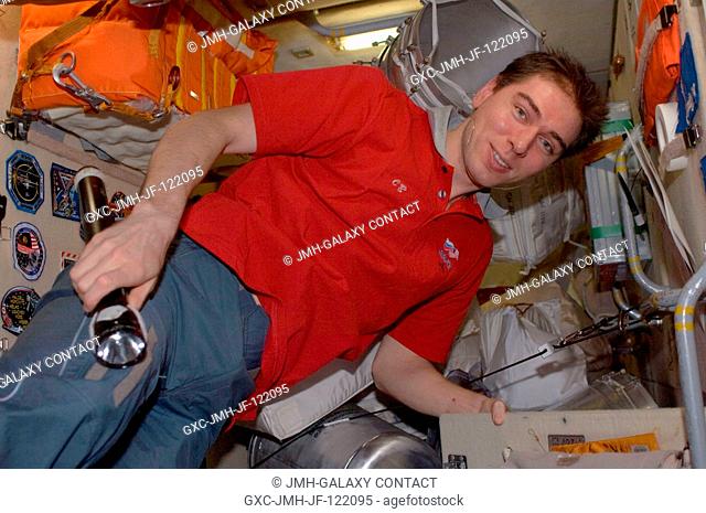 Russian Federal Space Agency cosmonaut Sergei Volkov, Expedition 17 commander, takes a moment for a photo as he works with equipment in the Zarya module of the...