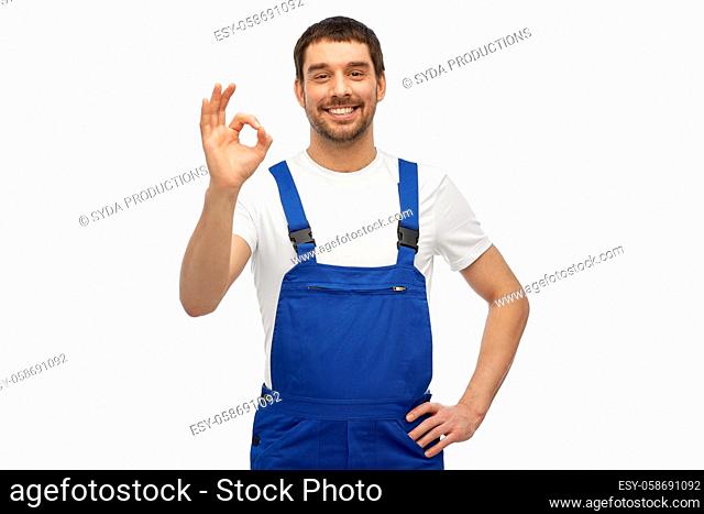happy smiling male worker or builder showing ok