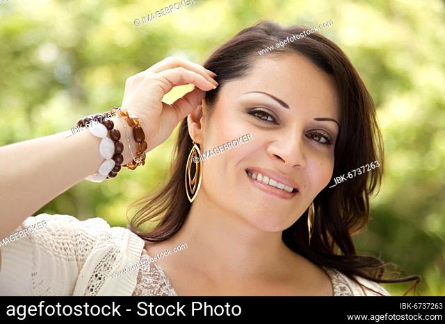 Attractive hispanic woman portrait in the park