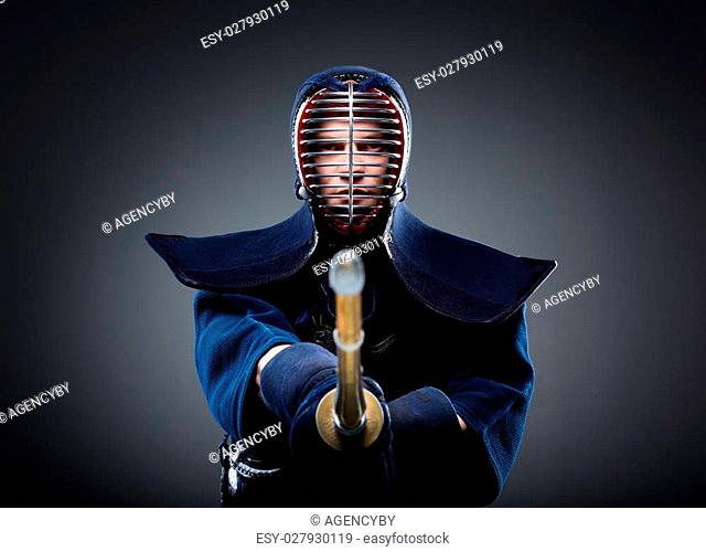 Portrait of kendo fighter with bokuto. Japanese martial art of sword fighting