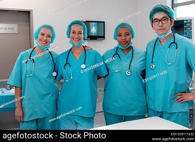 Portrait of diverse group of male and female doctors standing in operating theatre