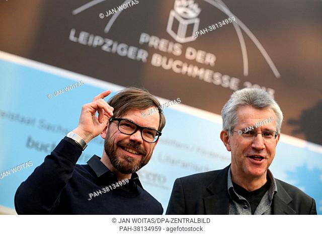 German author David Wagner (L) stands after receiving the Leipzig Book Fair Prize for fiction next to literature critic Helmut Boettinger at the Leipzig Book...