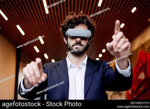 Young businessman enjoying wearing virtual reality headset