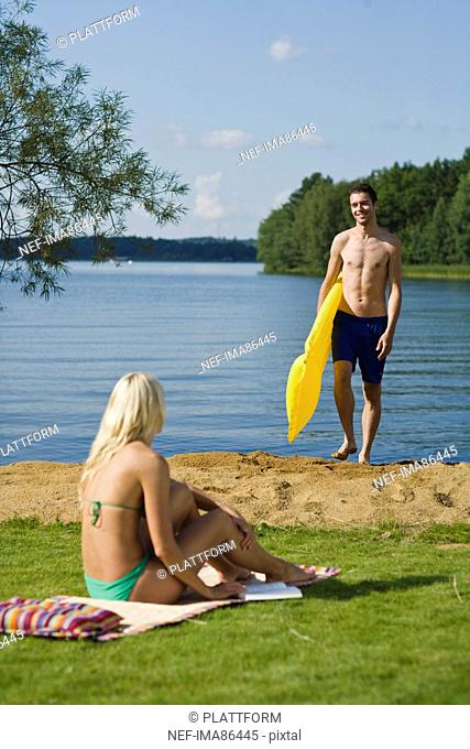 Mid adult couple beside lake