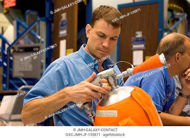 Astronaut Stanley G. Love, STS-122 mission specialist, participates in a stationshuttle emergency scenario training session in the Space Vehicle Mockup Facility...