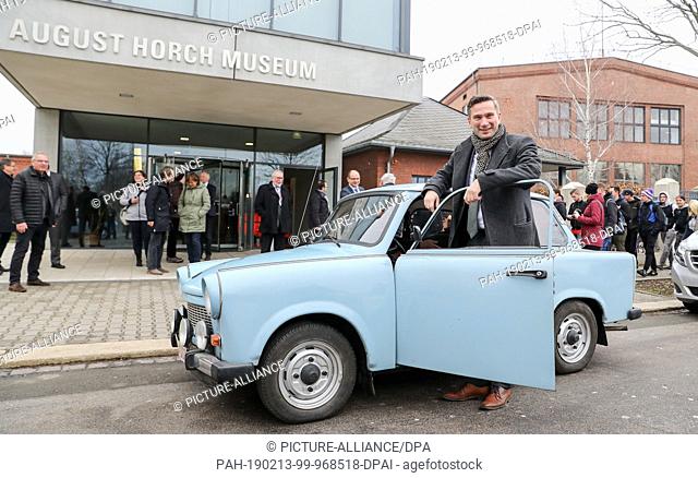 13 February 2019, Saxony, Zwickau: Martin Dulig, Minister of Economics of Saxony (SPD), stands in front of the Horch Museum next to a Trabant car after driving...