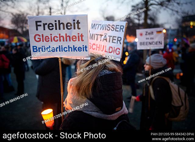 05 December 2020, Mecklenburg-Western Pomerania, Schwerin: Opponents of the government's current Corona measures are standing with signs (""Freiheit, Gleichheit