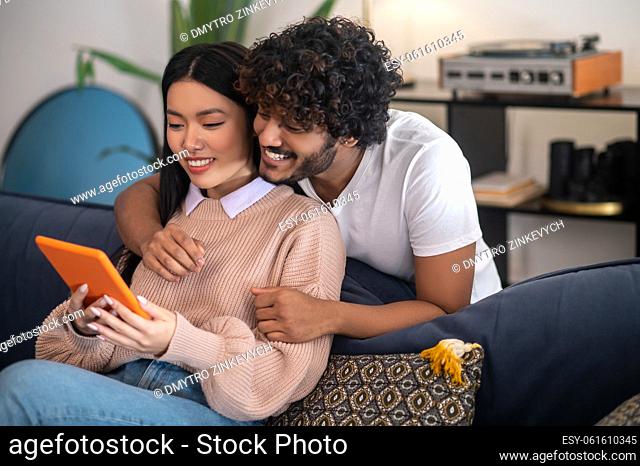 Video calling. Young cute couple having a video call and looking involved
