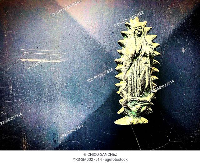 A golden metallic image of Our Lady of Guadalupe decorates a door in Mexico City, Mexico