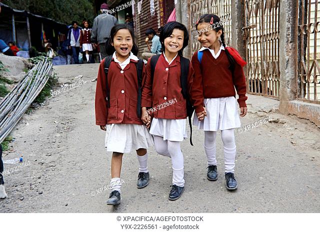 Young school girls in uniform walking home in the Chowrasta, Darjeeling