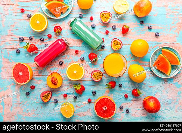 Variation of smoothies and refreshing drinks with fresh fruits for hot summer on blue background