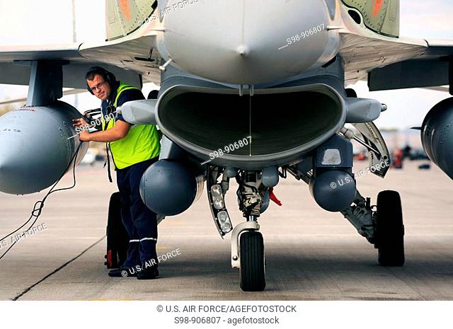 Alexsi, an Israeli Air Force, Crew Chief conducts pre-flight checks at Nellis Air Force Base before a training mission at Red Flag 09-4  Red Flag is a realistic...