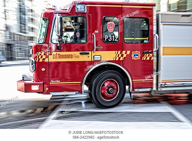 Toronto, Ontario, Canada Fire truck, racing along the street, responding to an emercency