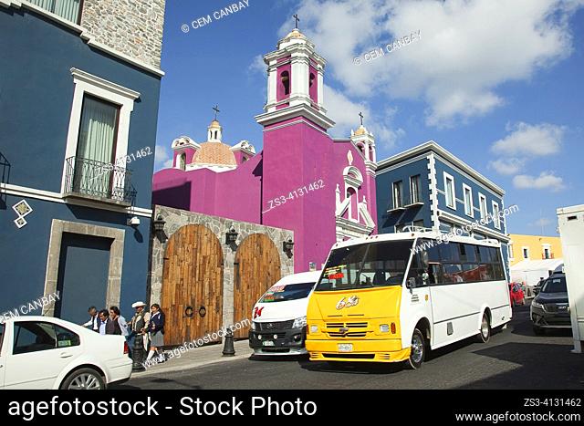 Local people and vehicles in front of the Capilla Del Cireneo Church in El Alto district at the historic center, Puebla, Puebla State, Mexico, Central America