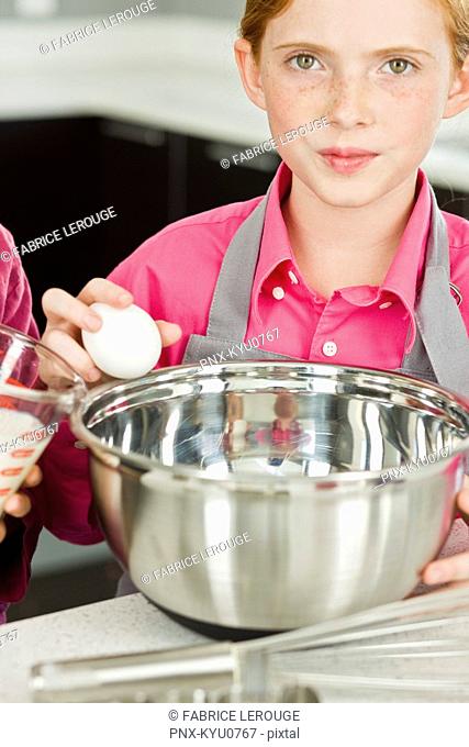 Portrait of a girl cooking food in the kitchen