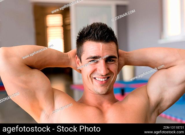 Handsome muscular man in gym