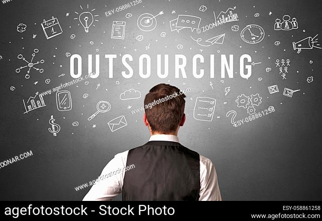 Rear view of a businessman with OUTSOURCING inscription, modern business concept