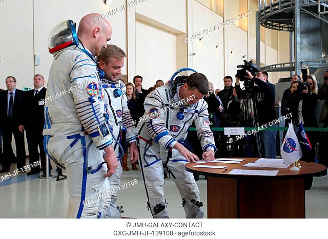 At the Gagarin Cosmonaut Training Center in Star City, Russia, Expedition 4041 Flight Engineer Reid Wiseman of NASA signs in for final qualification exams May 7...