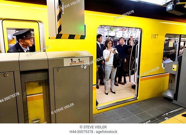 Japan, Honshu, Tokyo, Subway, Subway Train Showing Guard and Passengers