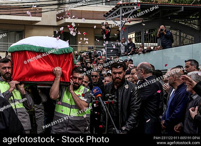 22 November 2023, Lebanon, Beirut: Mourners throw rose petals over one of the coffins of the two journalists, who were killed in an Israeli strike in south...