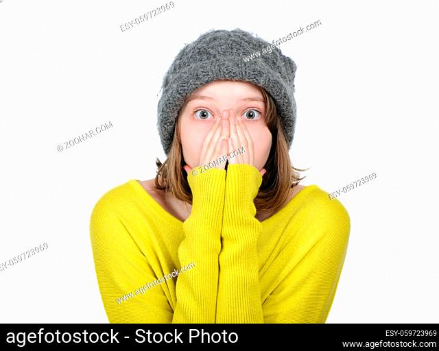 Portrait of pretty frightened girl covering her face