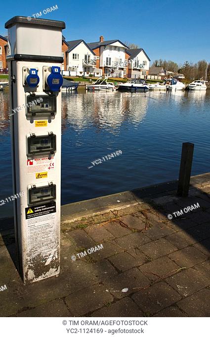 An electric supply for Boats to plug into on the river Chet at Loddon , Norfolk , England , Great Britain , Uk