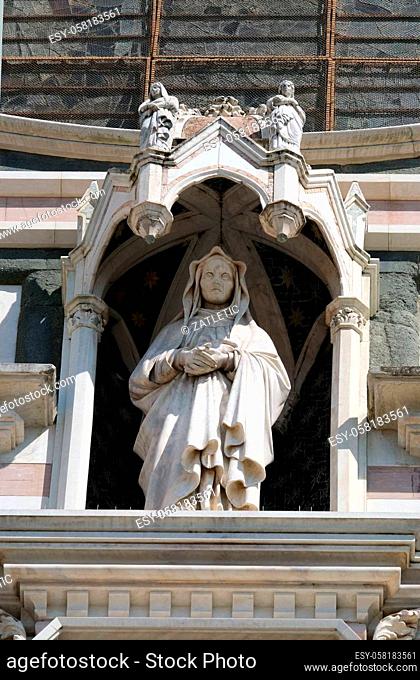 Statue on the portal of Basilica of Santa Croce (Basilica of the Holy Cross) - famous Franciscan church in Florence, Italy