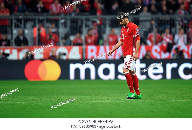 Munich's Javi Martinez leaves the field after receiving a yellow and red card during the first leg of the Champions League quarter final match between Bayern...