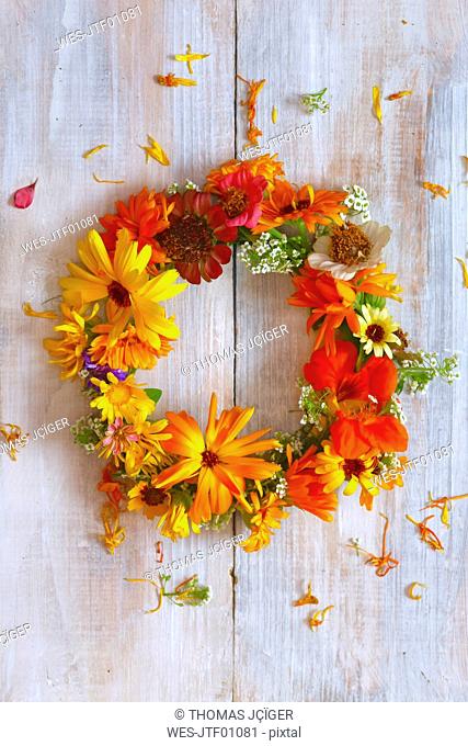 Wreath of colorful flowers on wood
