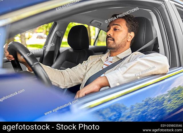 indian man or driver driving car