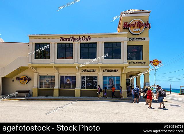 George Town, Cayman Islands, British West Indies - April 23, 2019: Tourists near the famous Hard Rock Cafe in George Town of Grand Cayman, Cayman Islands