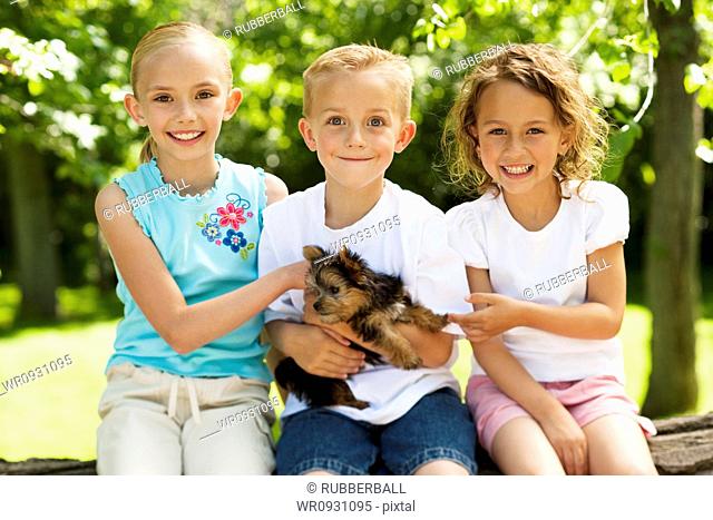 Three children with small dog
