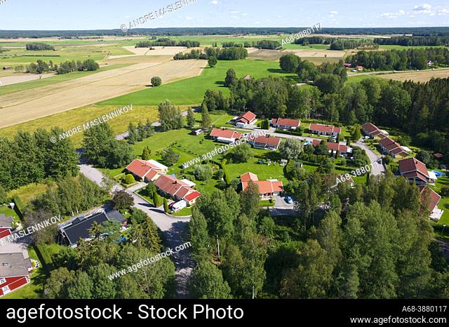 Part of Västerfärnebo with villas and the agricultural landscape behind